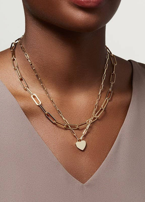 Golden Heart Layers Necklace with double-layer design and heart charms, crafted from 18K gold-finished stainless steel. Waterproof, tarnish-free, and hypoallergenic.