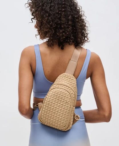 Woven neoprene women's sling backpack in Nude / Tan with adjustable strap and zippered compartments.