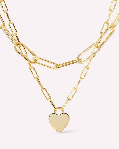 Golden Heart Layers Necklace with double-layer design and heart charms, crafted from 18K gold-finished stainless steel. Waterproof, tarnish-free, and hypoallergenic.