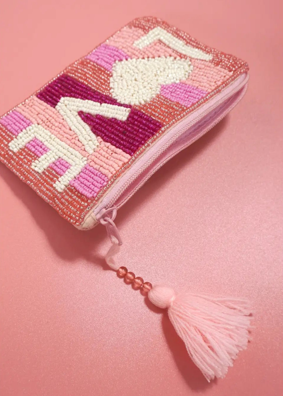 Pink seed bead coin purse with "Love" motif, zipper closure, and tassel detail.