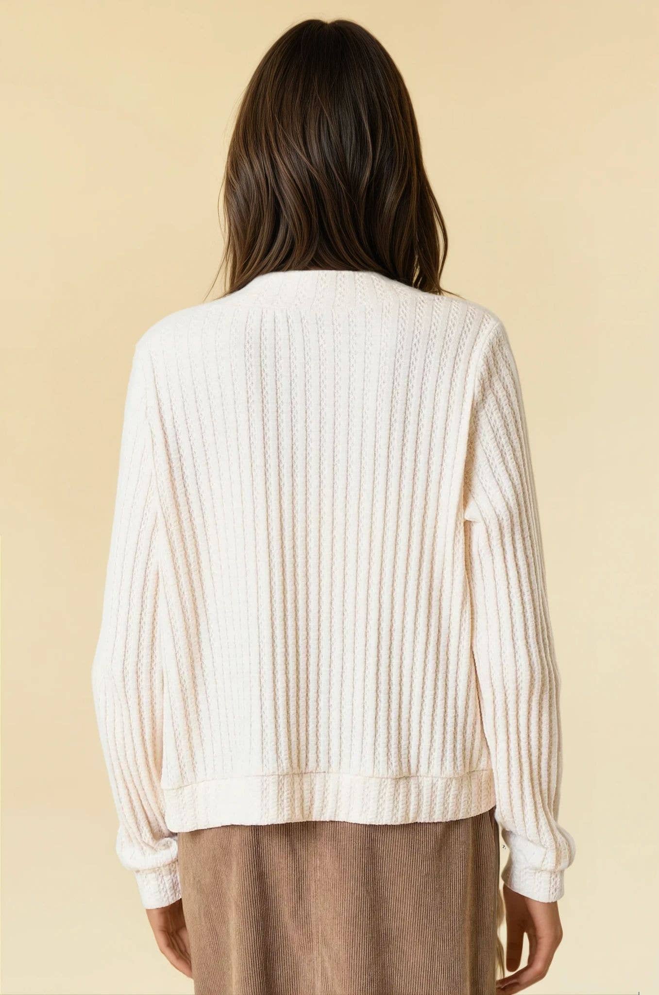 Bisque ribbed knit cardigan with a single-button closure and deep V-neckline.