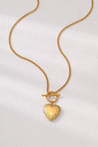 Gold locket necklace with a toggle closure, crafted from 18K gold-dipped stainless steel, tarnish-free and hypoallergenic.