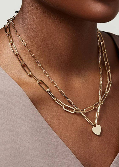 Golden Heart Layers Necklace with double-layer design and heart charms, crafted from 18K gold-finished stainless steel. Waterproof, tarnish-free, and hypoallergenic.