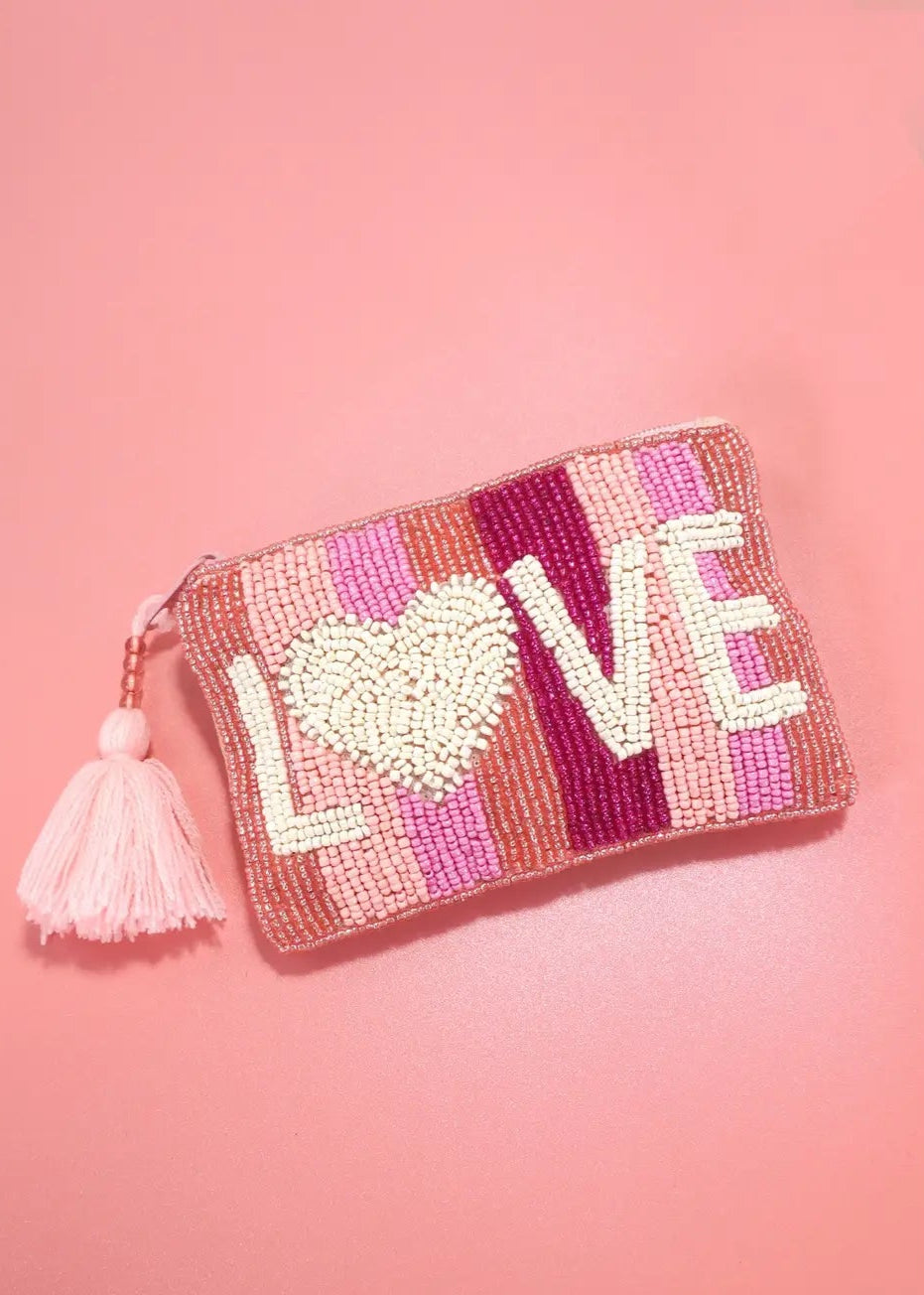 Pink seed bead coin purse with "Love" motif, zipper closure, and tassel detail.