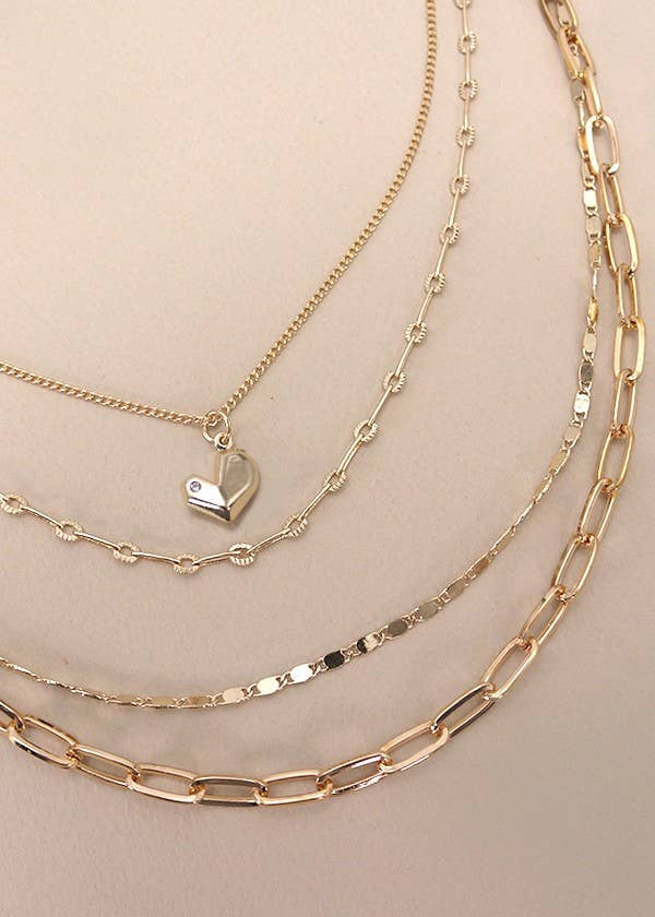 Multi-layer gold-plated heart charm necklace with layered link chains and delicate heart charm. 