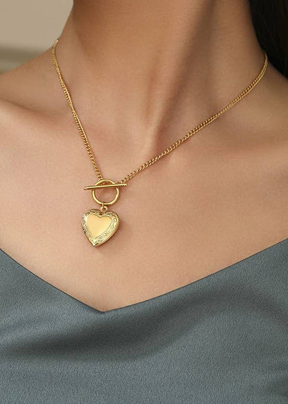 Gold locket necklace with a toggle closure, crafted from 18K gold-dipped stainless steel, tarnish-free and hypoallergenic.