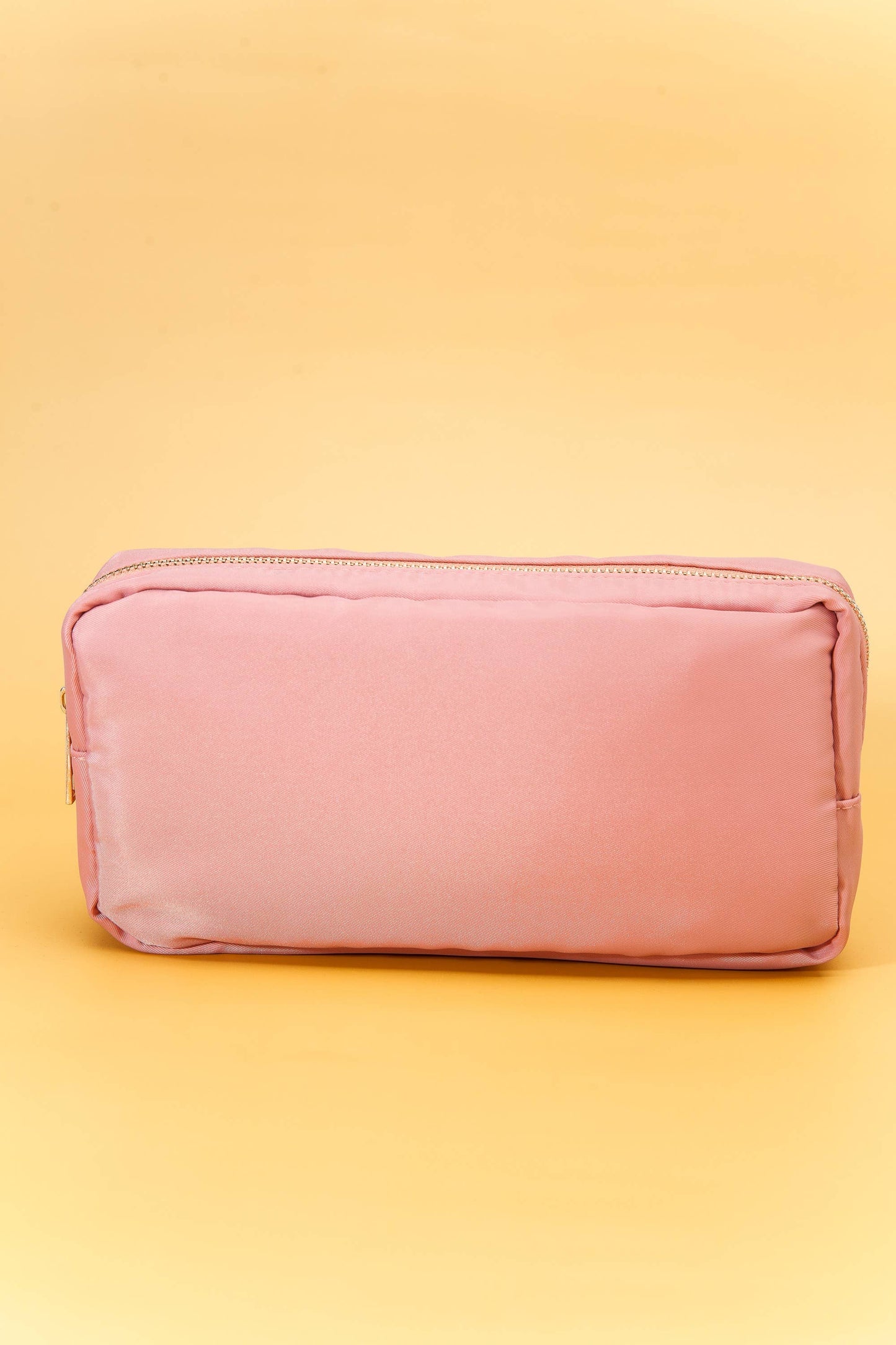 Small nylon cosmetic bag with gold-tone hardware and a zip closure, ideal for travel and everyday organization. 6 colors to choose from: Black, Green, Blue, Peach, White, Pink. 