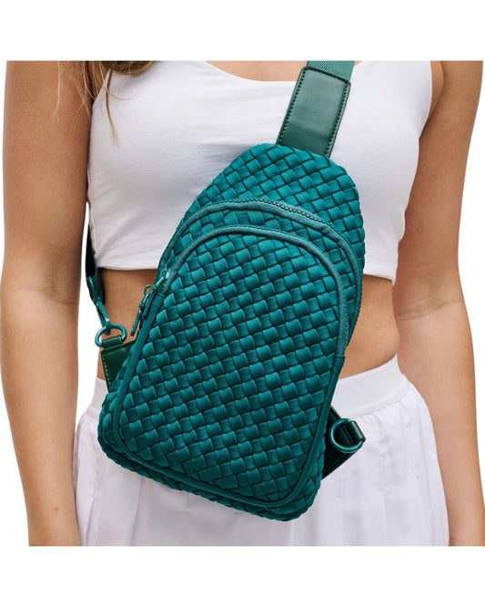 Woven neoprene women's sling backpack in Forest Green with adjustable strap and zippered compartments.