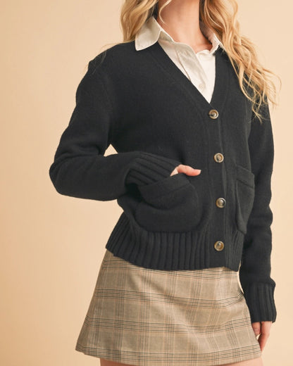 Black button-up cardigan with front pockets and a slightly oversized fit.