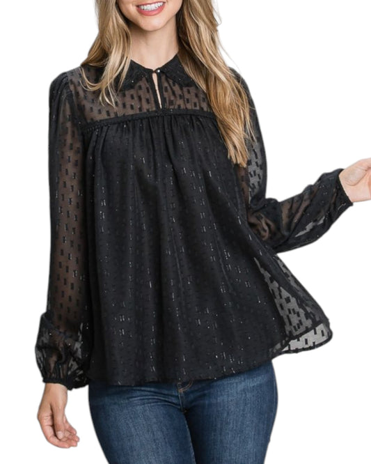 A black sheer jacquard blouse with shimmering gold accents, featuring a keyhole neckline, long voluminous sleeves, and a feminine gathered yoke detail.