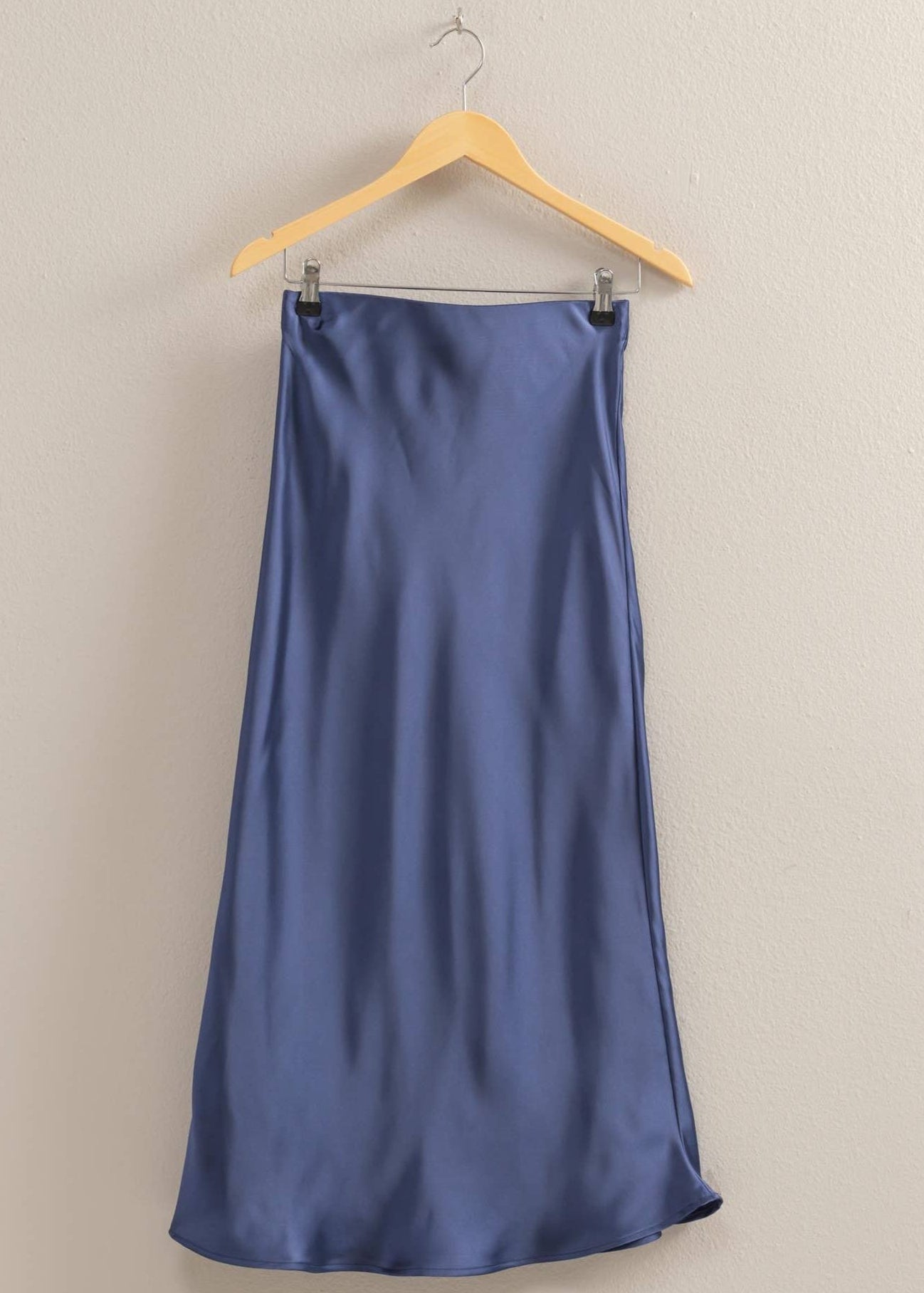 Blue Satin midi skirt with a mid-rise silhouette, pull-on elastic waist, and breezy hem.