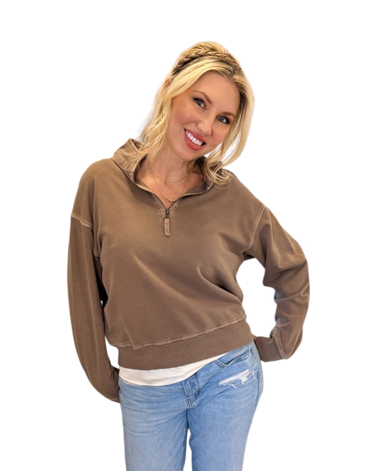 Woman smiling and wearing jeans with the Mocha French Terry Half-Zip Sweatshirt made from 100% cotton with a washed finish, featuring a half-zip design, ribbed hem and cuffs, and a relaxed fit for casual styling.