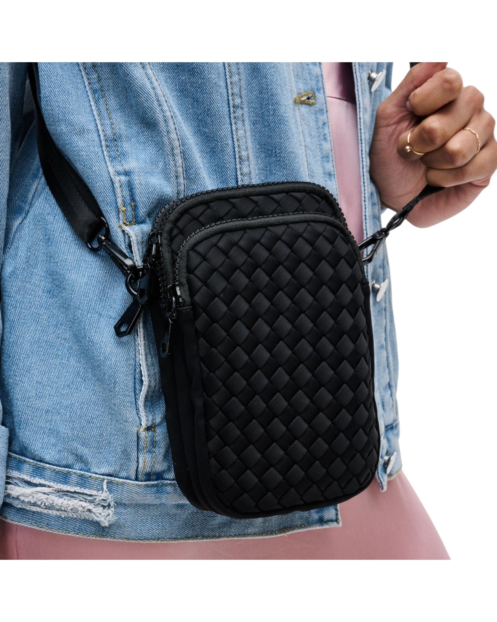 Compact neoprene cell phone crossbody bag with three zippered compartments and adjustable strap in Black.