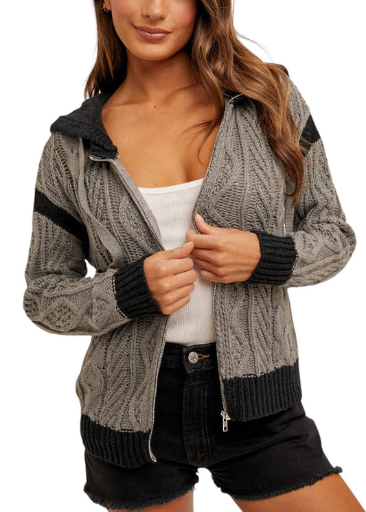 Women's color-block cable knit hoodie sweater with zippered front, soft cotton blend, and cozy hood in gray and black. 