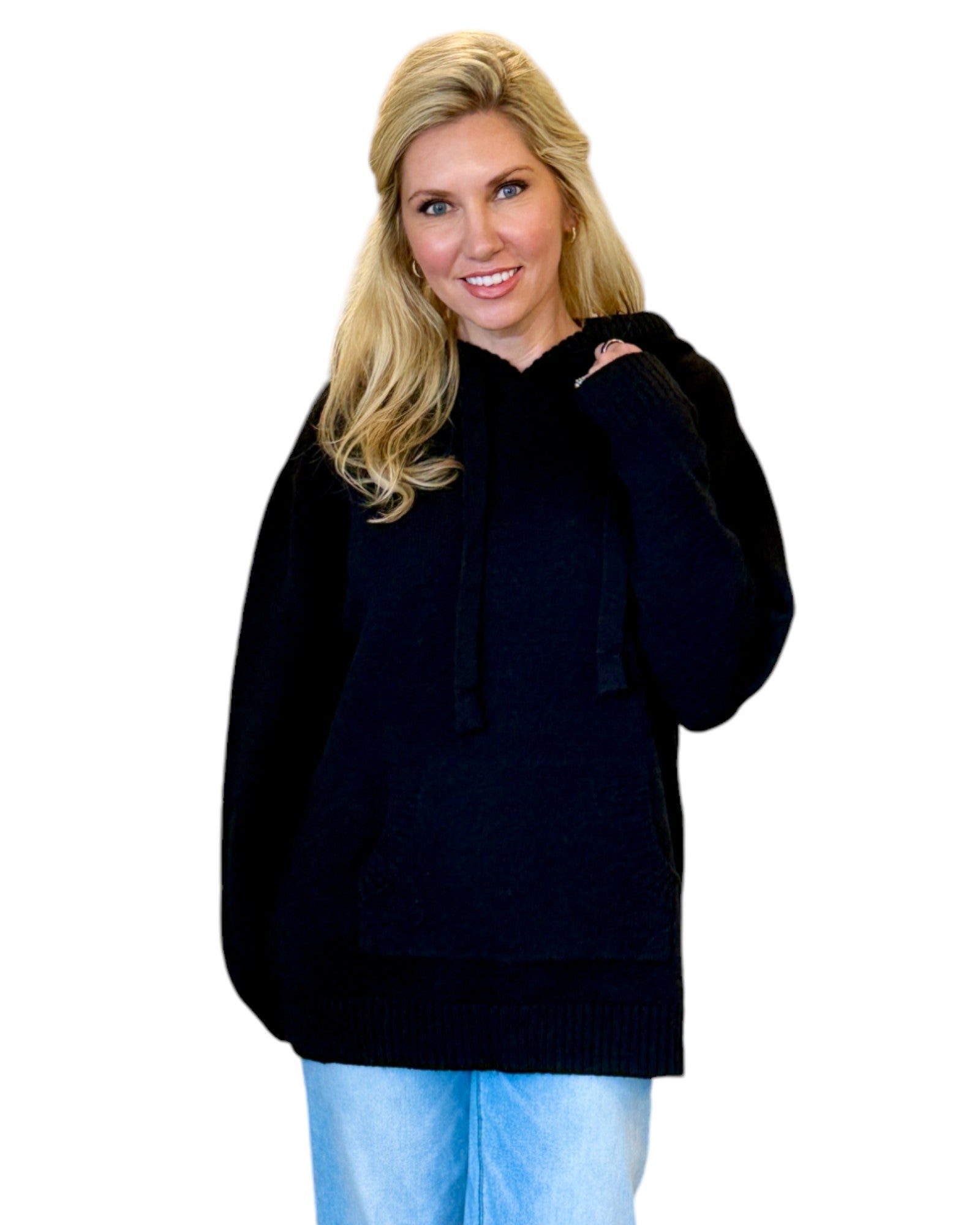 Woman wearing a soft, black oversized hoodie sweater.