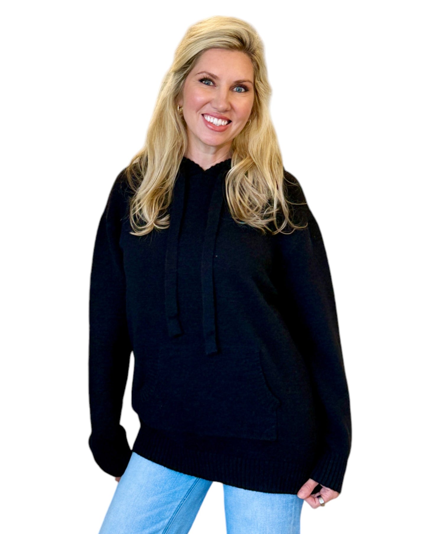 Woman wearing a soft, black oversized hoodie sweater.