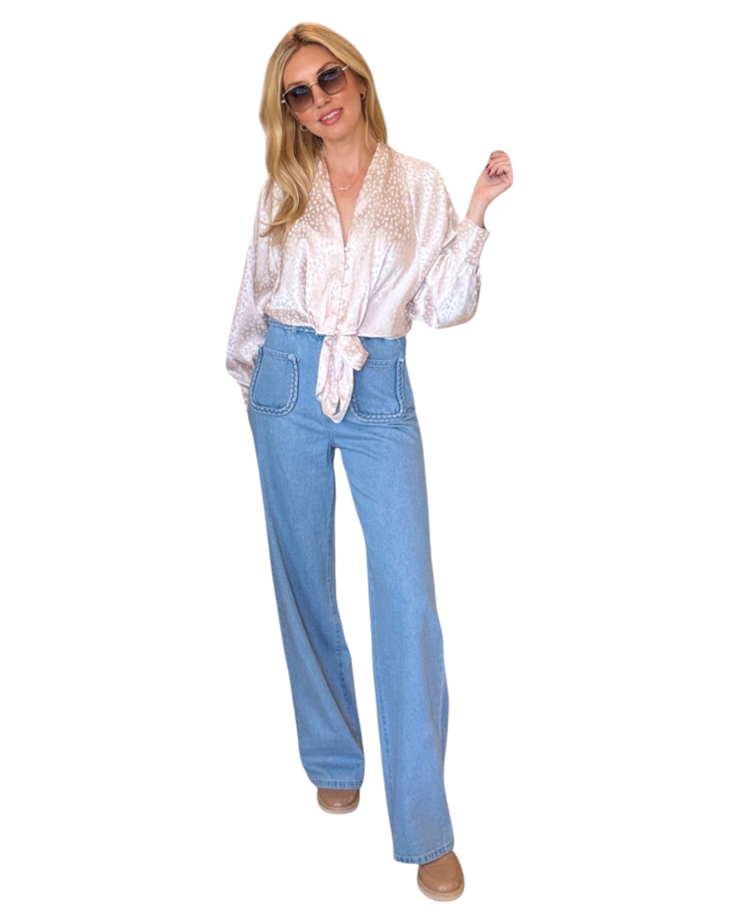 High waist blue denim jeans with braided waistband detail, straight wide-leg fit, and extra-high waist. Made from no-stretch fabric with front pockets and a longer inseam, ideal for a slender silhouette. Medium blue washed denim.