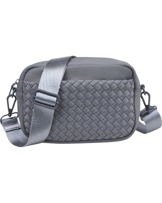 Woven neoprene crossbody bag with adjustable strap, top zip closure, and convenient side pockets.