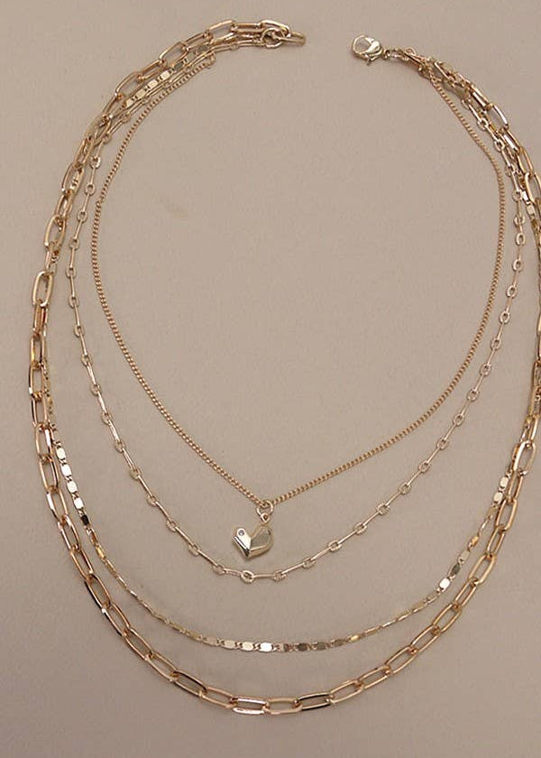 Multi-layer gold-plated heart charm necklace with layered link chains and delicate heart charm. 