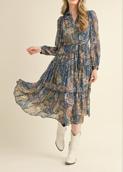 Blue paisley midi dress with a collared neckline, long sheer sleeves, and tiered ruffle skirt.