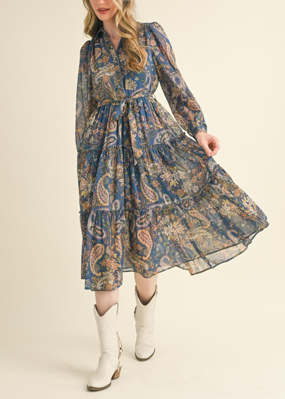 Blue paisley midi dress with a collared neckline, long puff sleeves, and tiered ruffle skirt.