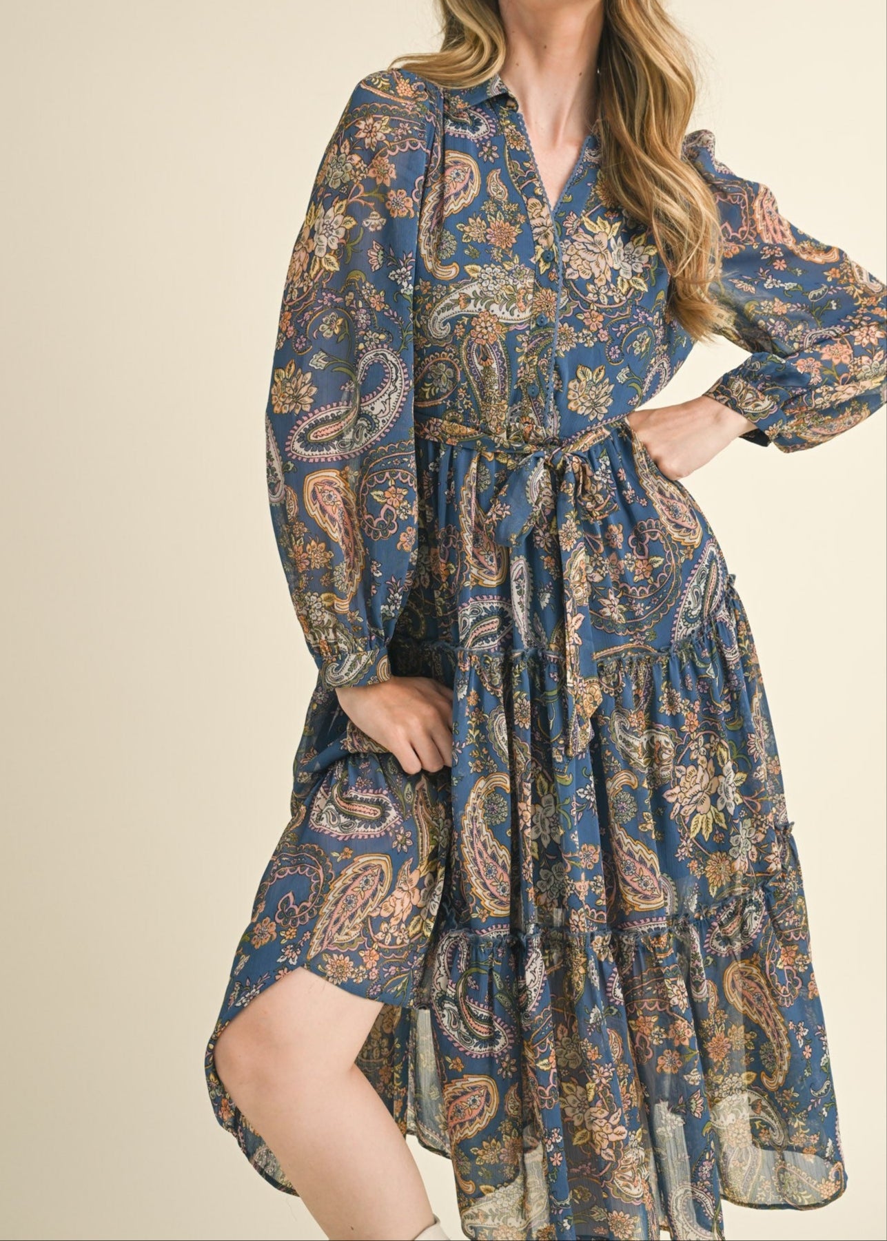 Blue paisley midi dress with a collared neckline, long puff sleeves, and tiered ruffle skirt.