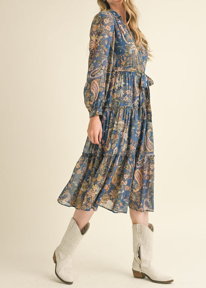 Blue paisley midi dress with a collared neckline, long puff sleeves, and tiered ruffle skirt.