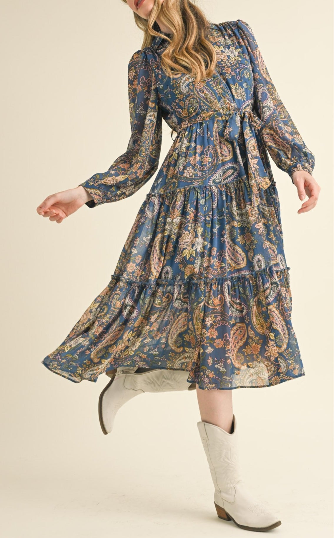 Blue paisley midi dress with a collared neckline, long puff sleeves, and tiered ruffle skirt.