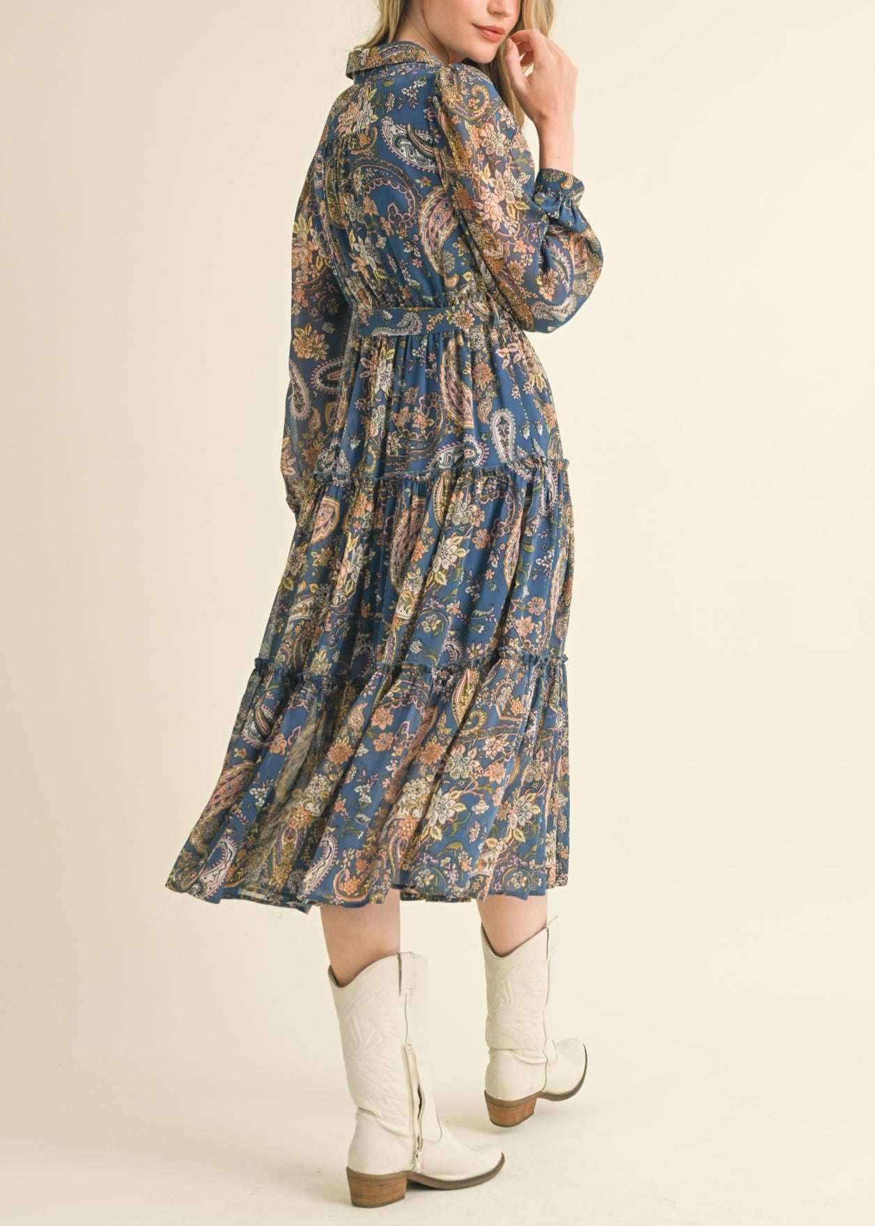 Blue paisley midi dress with a collared neckline, long puff sleeves, and tiered ruffle skirt.