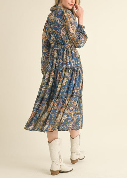 Blue paisley midi dress with a collared neckline, long puff sleeves, and tiered ruffle skirt.