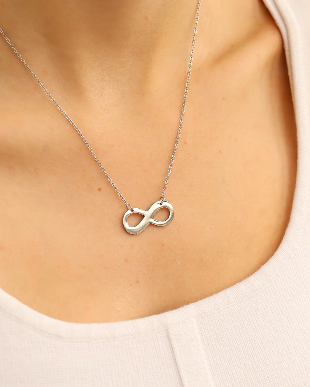 Stainless silver dainty necklace with an infinity symbol pendant. Waterproof and tarnish-resistant.