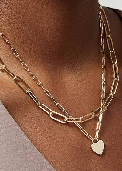 Golden Heart Layers Necklace with double-layer design and heart charms, crafted from 18K gold-finished stainless steel. Waterproof, tarnish-free, and hypoallergenic.