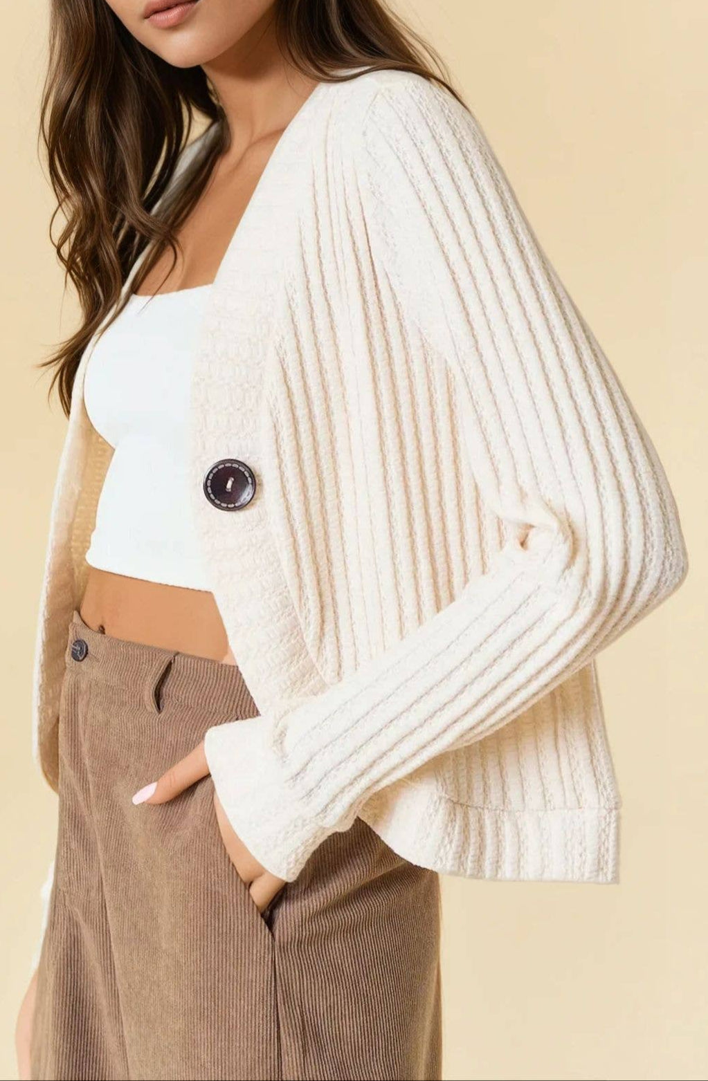 Bisque ribbed knit cardigan with a single-button closure and deep V-neckline.