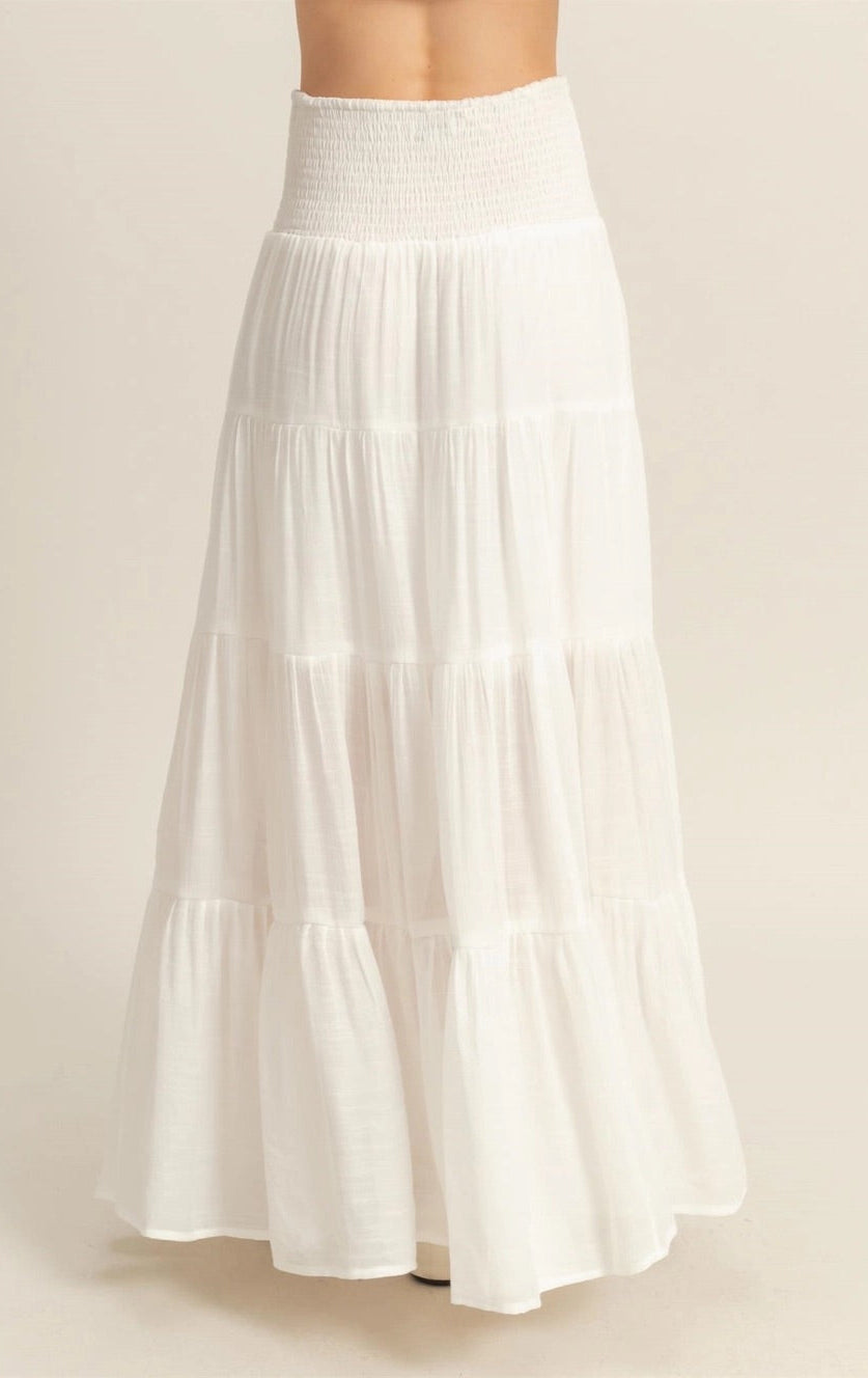 White tiered maxi skirt with a smocked elastic waistband and ankle-skimming hem.