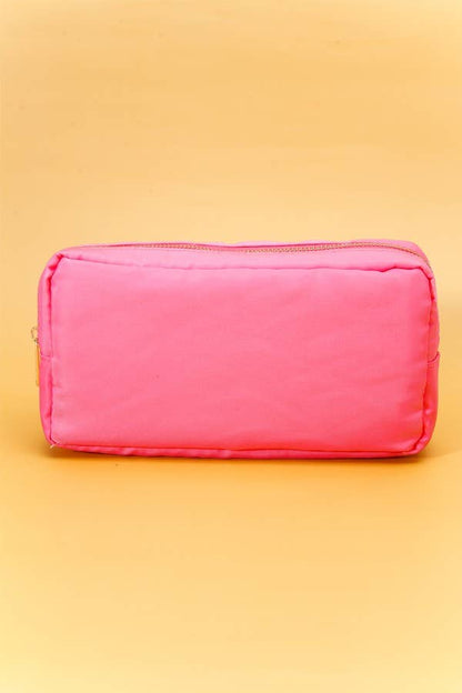 Small nylon cosmetic bag with gold-tone hardware and a zip closure, ideal for travel and everyday organization. 