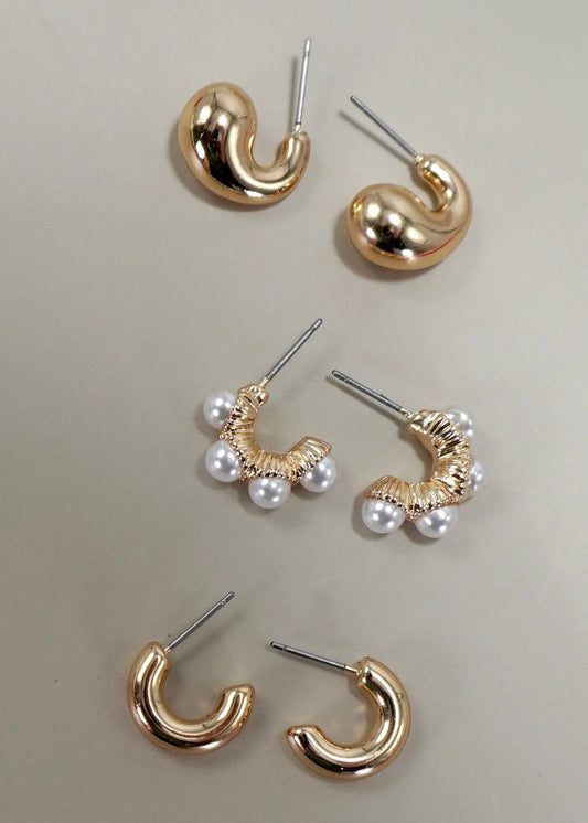 Set of 3 gold-plated huggie hoop earrings, including one pair with pearl accents and hypoallergenic titanium posts.